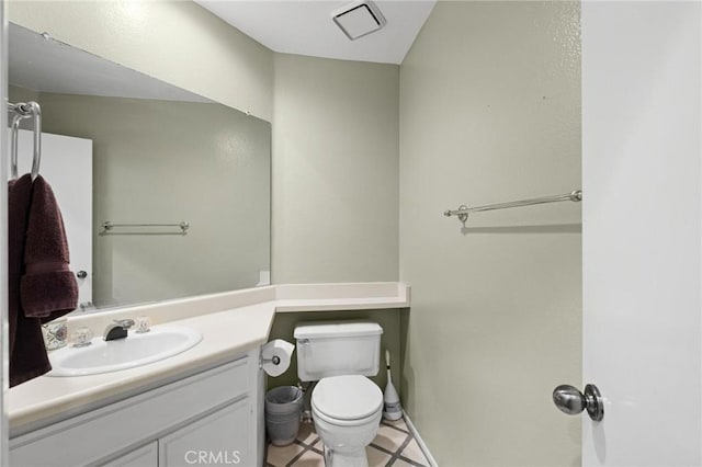 bathroom with tile patterned floors, vanity, and toilet