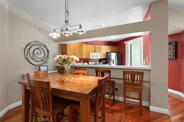 dining room featuring sink and light hardwood / wood-style floors