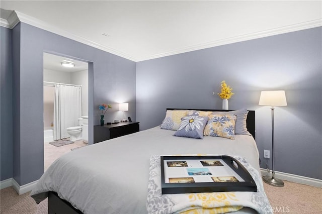 bedroom featuring carpet, ornamental molding, and ensuite bath