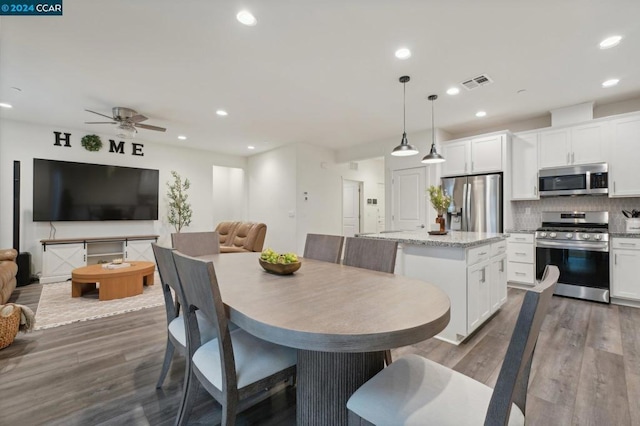 dining space featuring dark hardwood / wood-style floors and ceiling fan