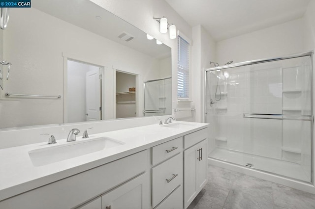 bathroom with vanity and a shower with shower door