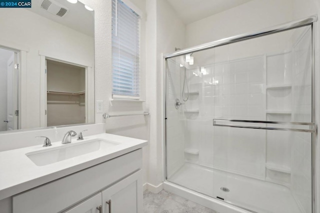 bathroom featuring vanity and an enclosed shower