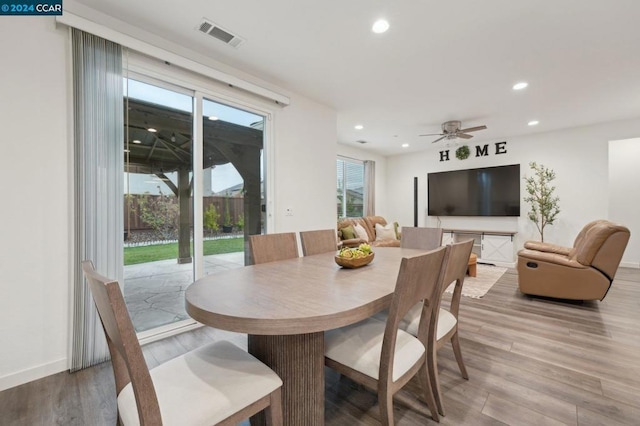 dining area featuring hardwood / wood-style floors and ceiling fan