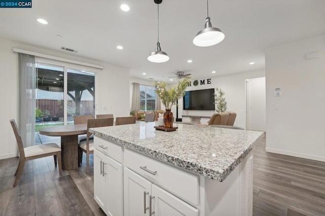 kitchen featuring a center island, dark hardwood / wood-style flooring, white cabinets, and hanging light fixtures