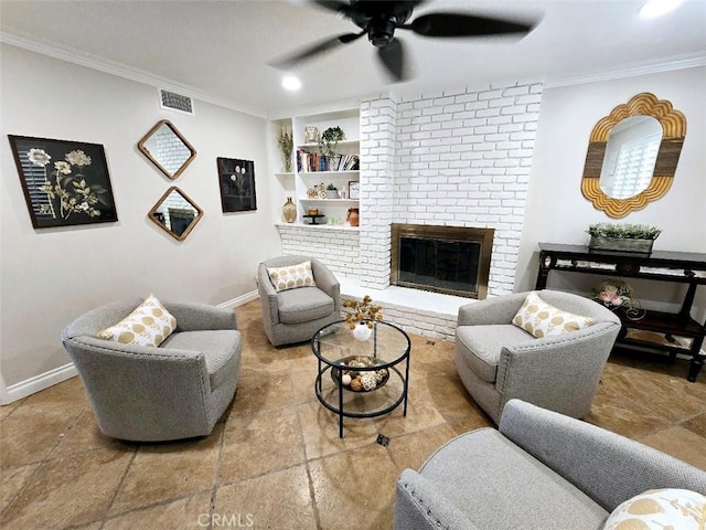 living room with built in shelves, crown molding, a fireplace, and ceiling fan