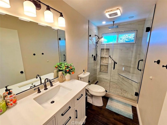 bathroom with toilet, a shower with door, vanity, and hardwood / wood-style flooring