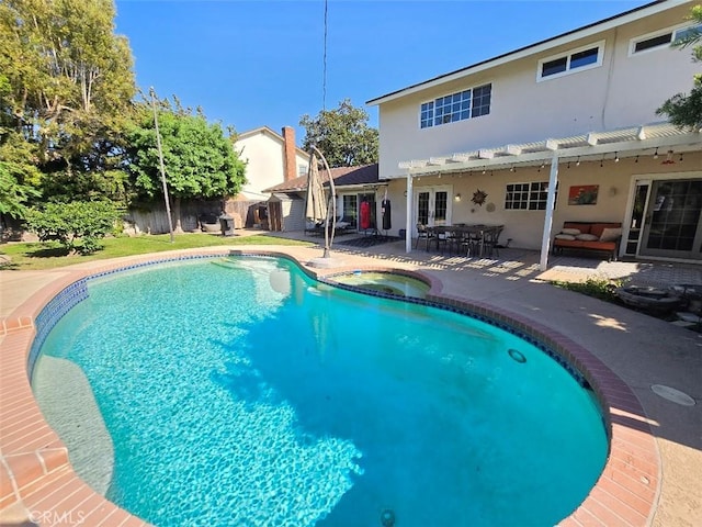 view of swimming pool featuring outdoor lounge area, an in ground hot tub, french doors, and a patio