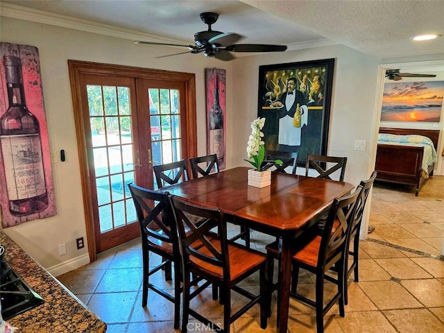 dining room with a textured ceiling, ceiling fan, crown molding, and french doors