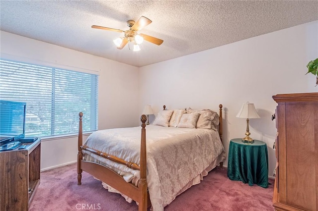 bedroom with ceiling fan, carpet, and a textured ceiling