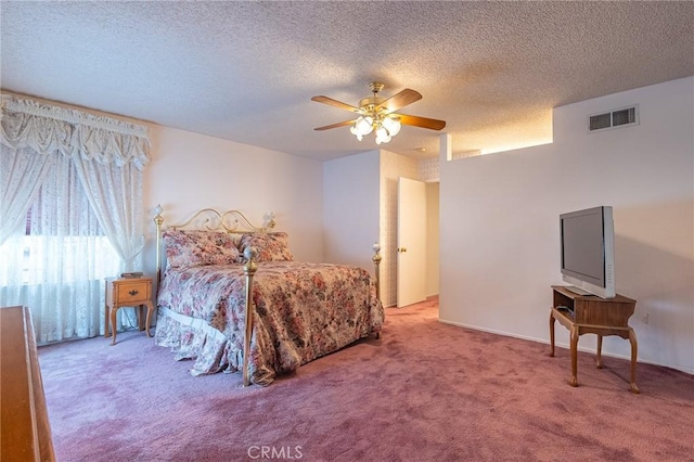 carpeted bedroom featuring ceiling fan and a textured ceiling