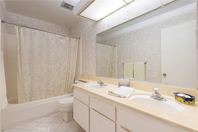 full bathroom with vanity, toilet, tile patterned floors, and shower / bath combo with shower curtain