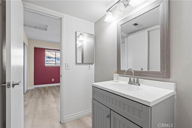 bathroom featuring hardwood / wood-style flooring and vanity