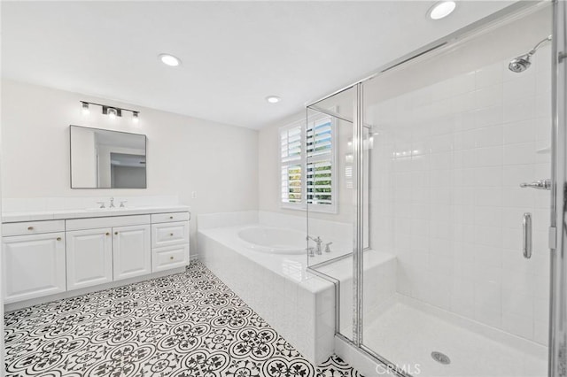 bathroom with shower with separate bathtub and vanity