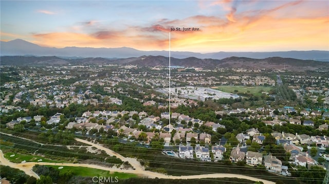 aerial view at dusk featuring a mountain view