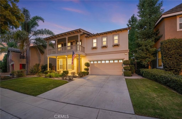 mediterranean / spanish home featuring a lawn, a garage, and a balcony