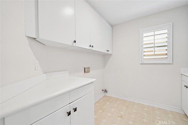 clothes washing area with cabinets and washer hookup