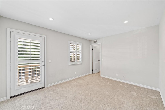 unfurnished room with light colored carpet