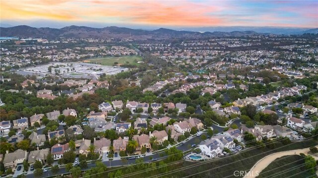 aerial view at dusk featuring a mountain view