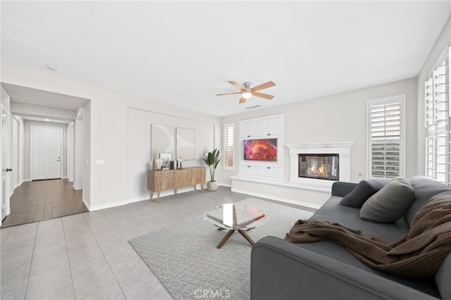 tiled living room with ceiling fan