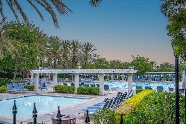 pool at dusk with a pergola