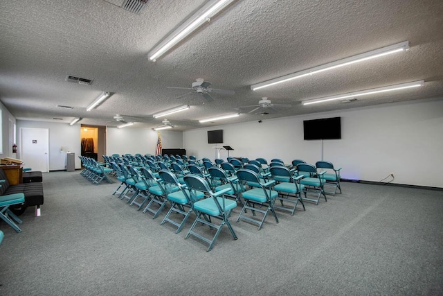 interior space with ceiling fan and a textured ceiling