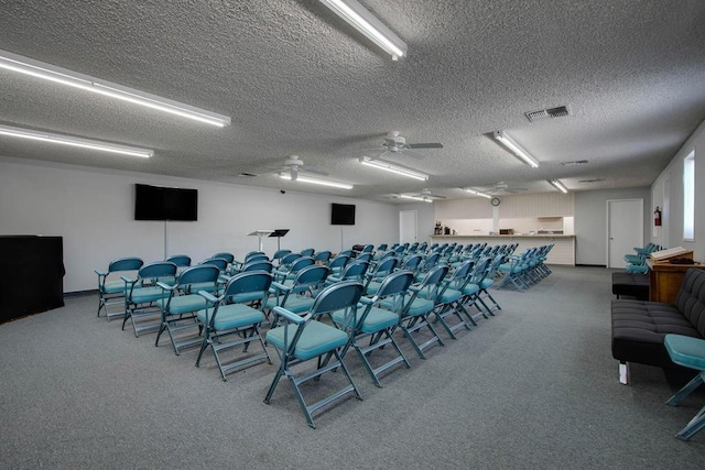 interior space with a textured ceiling and ceiling fan