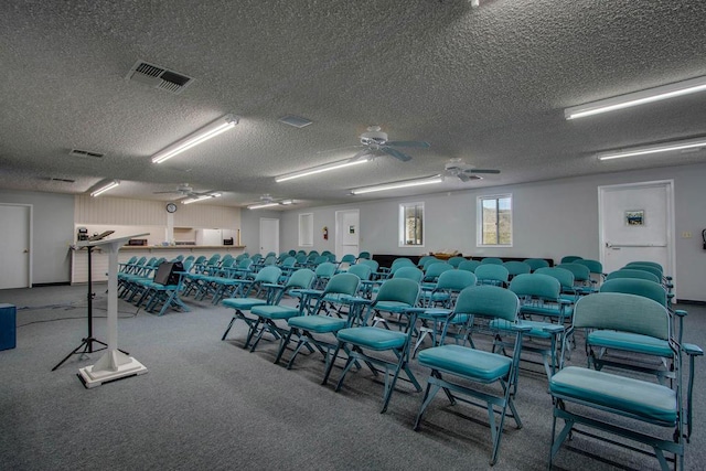 interior space featuring carpet flooring, ceiling fan, and a textured ceiling