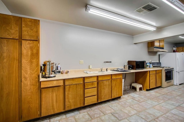 kitchen with white refrigerator and gas range