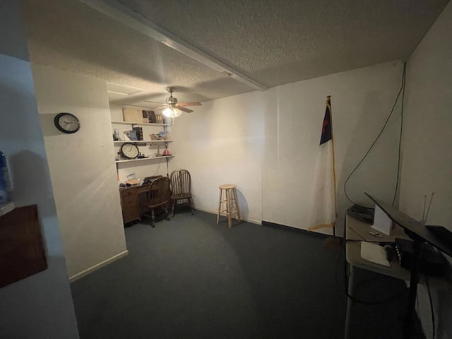 interior space featuring ceiling fan, carpet floors, and a textured ceiling