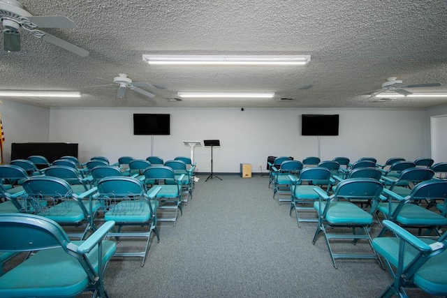 gym featuring carpet, ceiling fan, and a textured ceiling