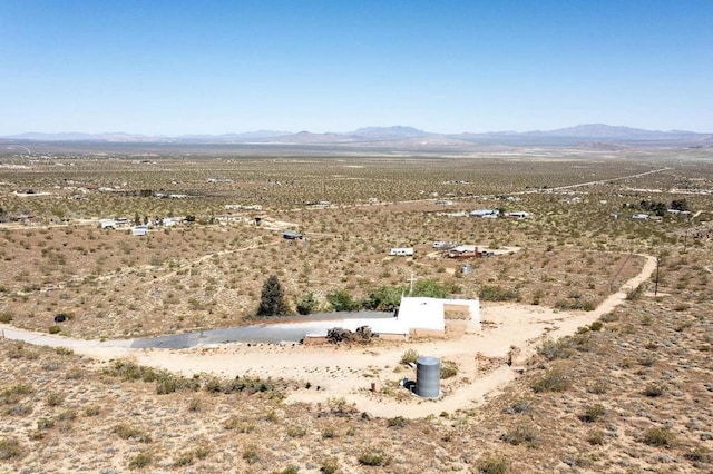 birds eye view of property featuring a mountain view