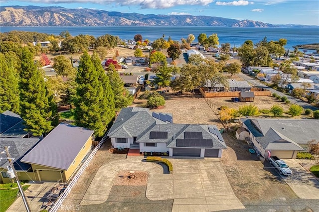 birds eye view of property with a water and mountain view