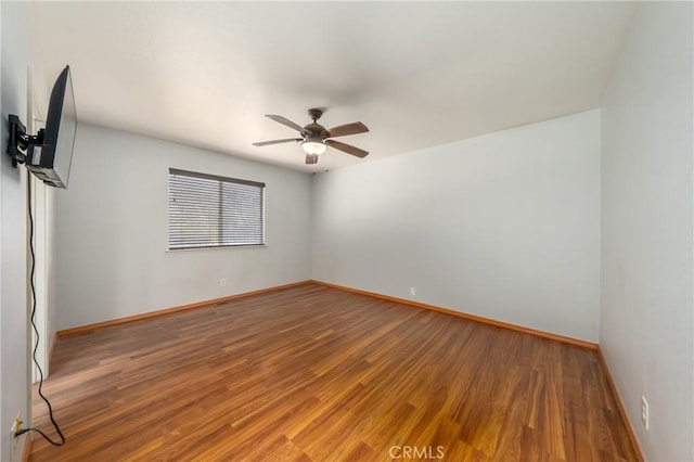 unfurnished room with hardwood / wood-style floors and ceiling fan