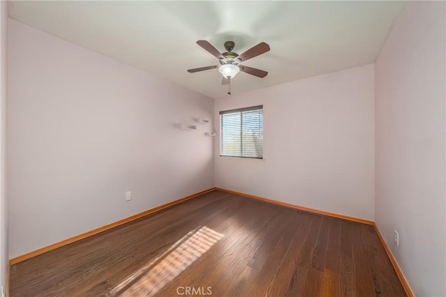 unfurnished room featuring ceiling fan and dark hardwood / wood-style flooring