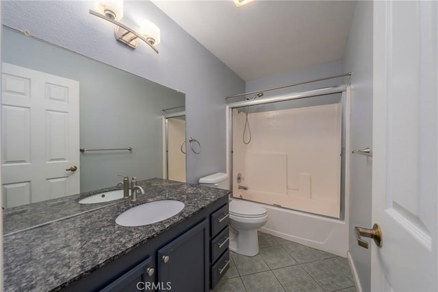 full bathroom featuring toilet, vanity, tile patterned floors, and bath / shower combo with glass door