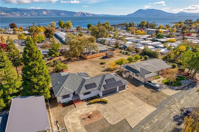 birds eye view of property with a water and mountain view