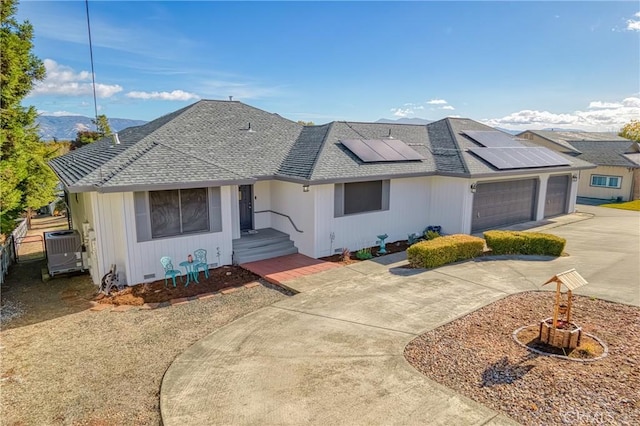 single story home featuring a garage and solar panels