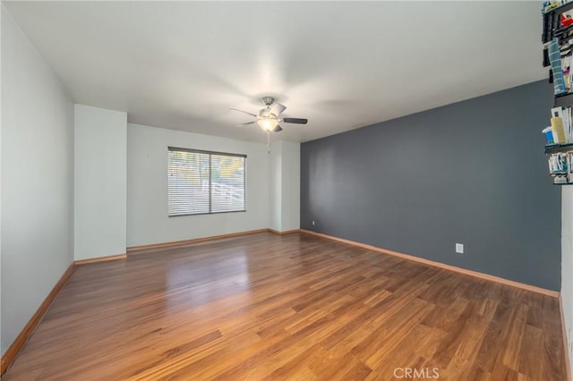 spare room featuring ceiling fan and hardwood / wood-style flooring