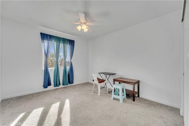 misc room with light carpet and ceiling fan