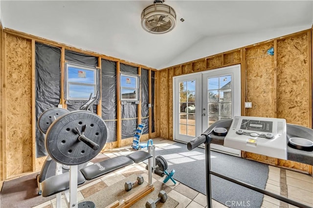 workout area featuring french doors, light tile patterned flooring, and lofted ceiling