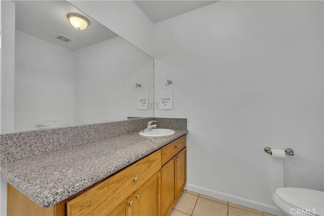 bathroom featuring toilet, vanity, and tile patterned floors