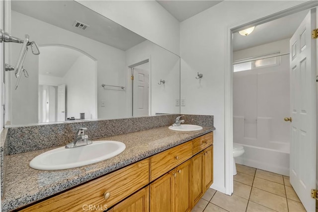 bathroom with tile patterned flooring, vanity, and toilet