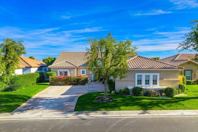 mediterranean / spanish-style home with a front yard