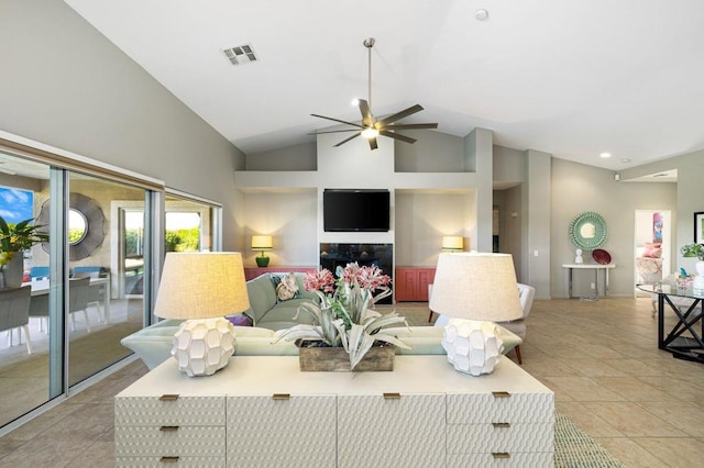 tiled living room with ceiling fan and high vaulted ceiling