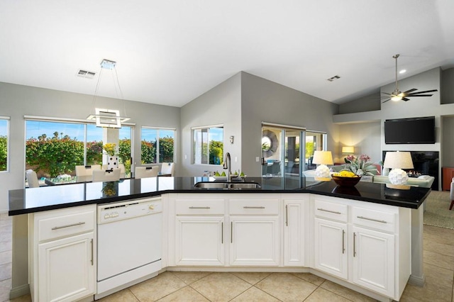 kitchen with white dishwasher, sink, vaulted ceiling, light tile patterned floors, and white cabinetry