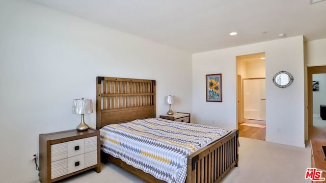 carpeted bedroom featuring ensuite bathroom