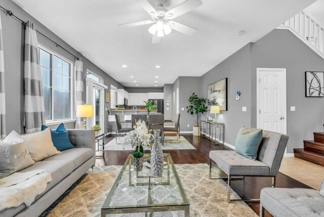 living room featuring ceiling fan and wood-type flooring