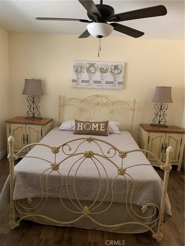 bedroom with ceiling fan and dark hardwood / wood-style floors