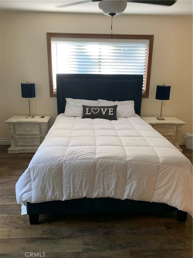 bedroom with ceiling fan and dark wood-type flooring