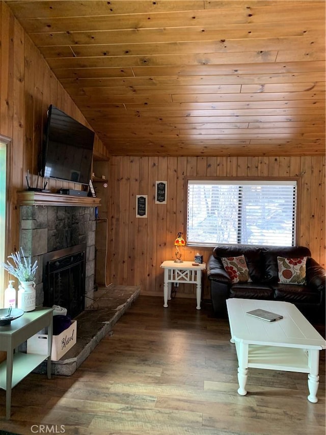 unfurnished living room with a fireplace, wooden ceiling, hardwood / wood-style floors, and vaulted ceiling